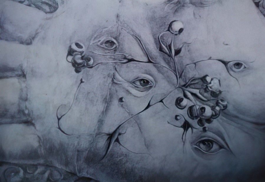 Pencil drawing of the palm of a hand with eyes in it.